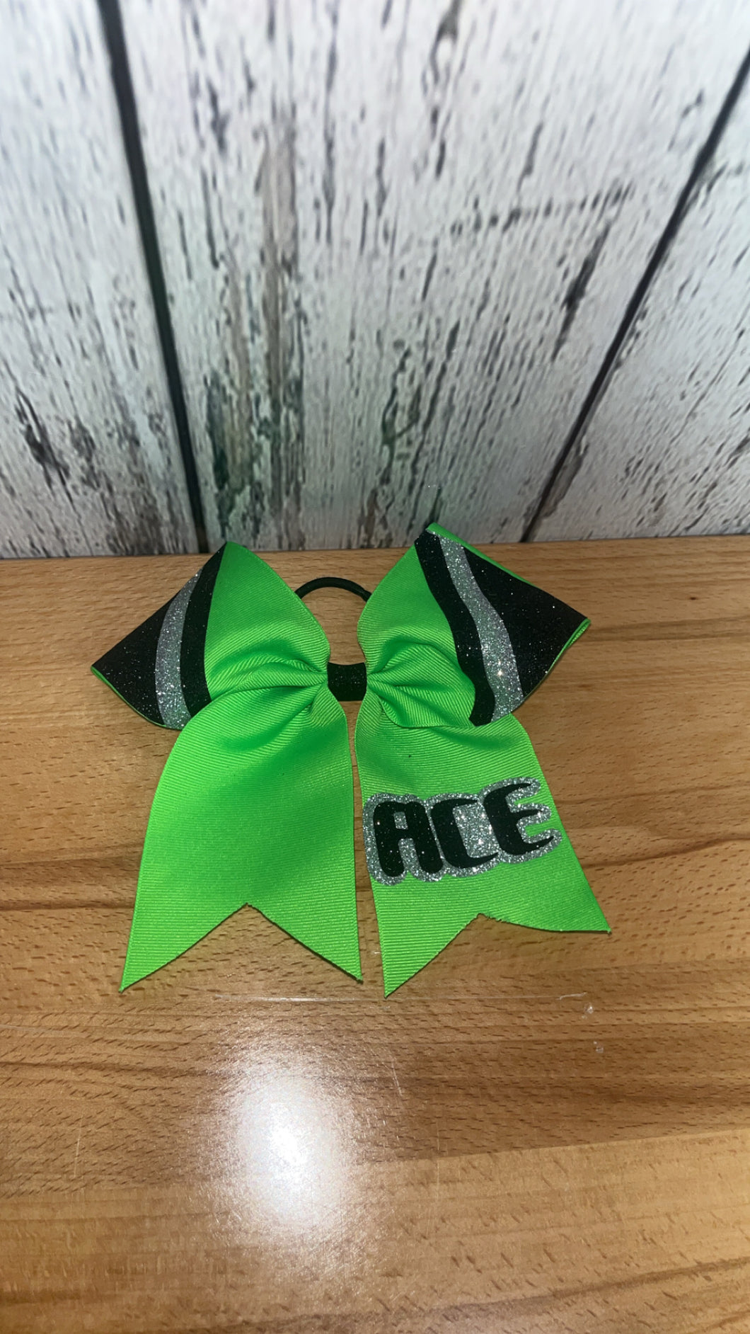 ACE lime green, silver, and black practice bow